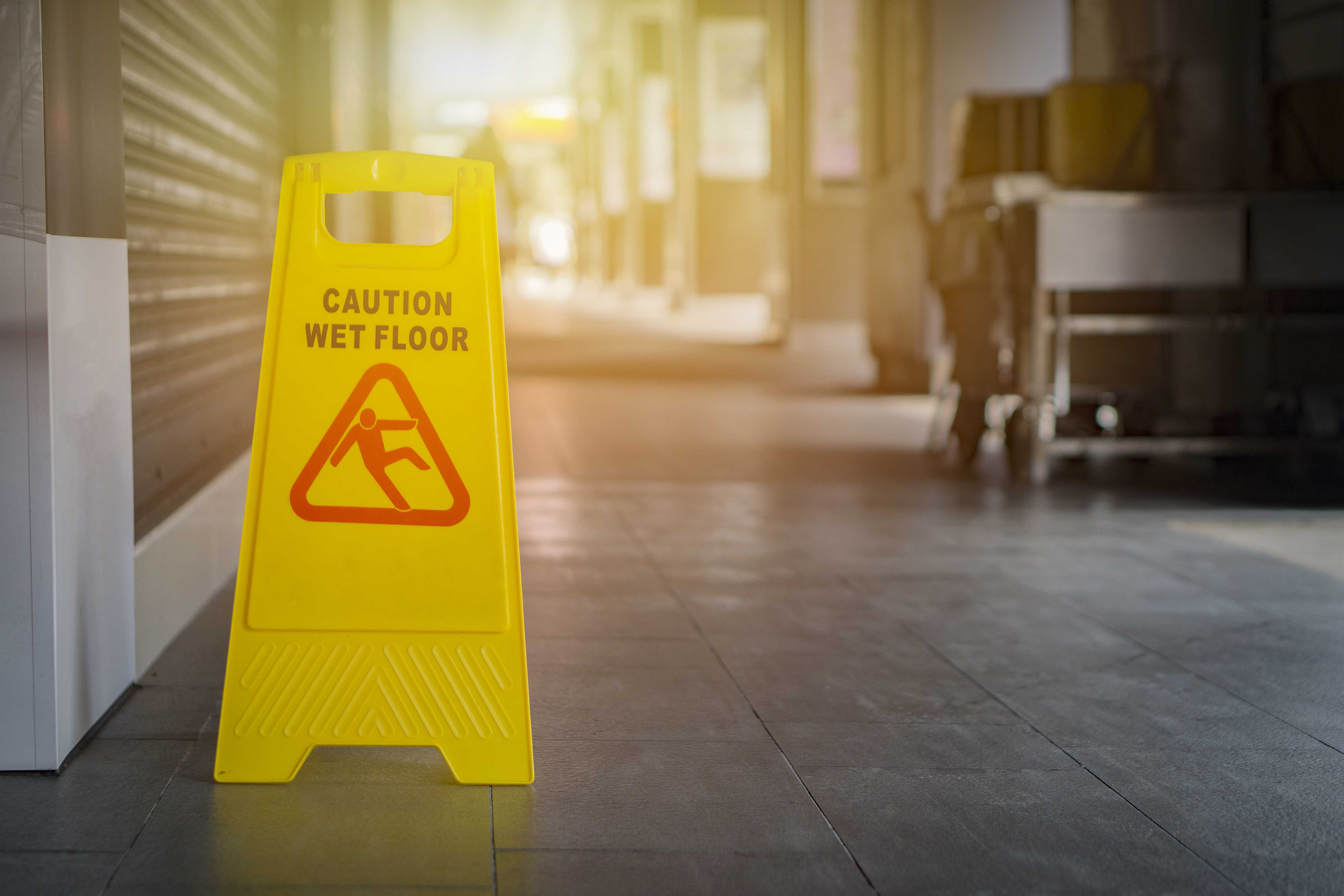 Caution Wet Floor sign on tile floor