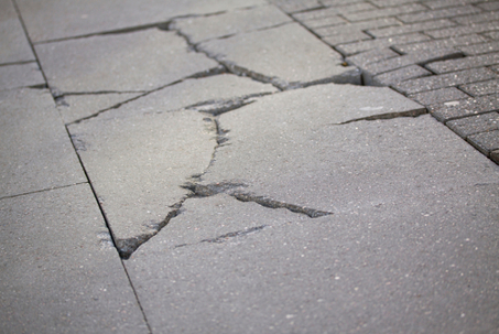 City sidewalk with cracks in it.