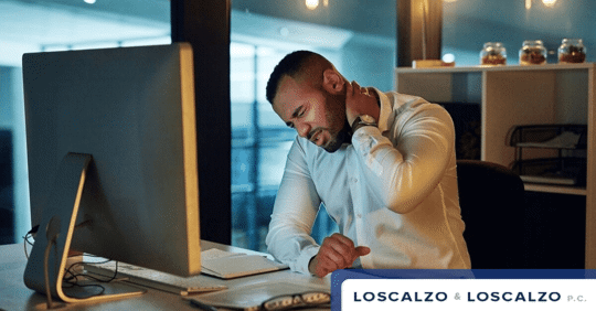 man rubbing his neck