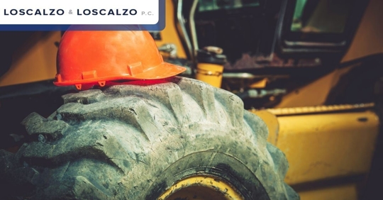 Close up of a forklift tire with a safety cone on top