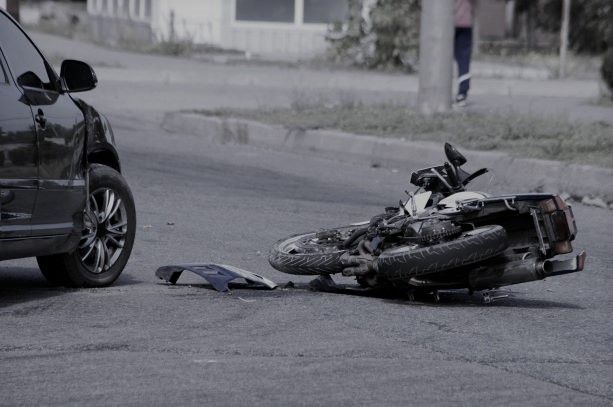 crushed motorcycle lying in the middle of a New York street