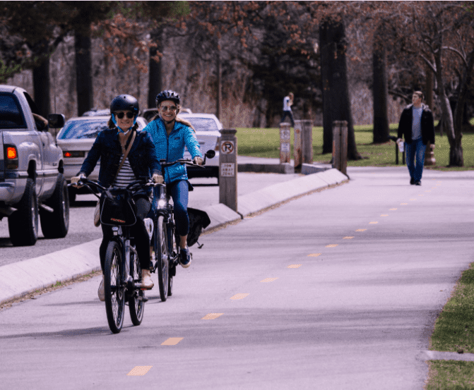 two women riding bicycles in new york city